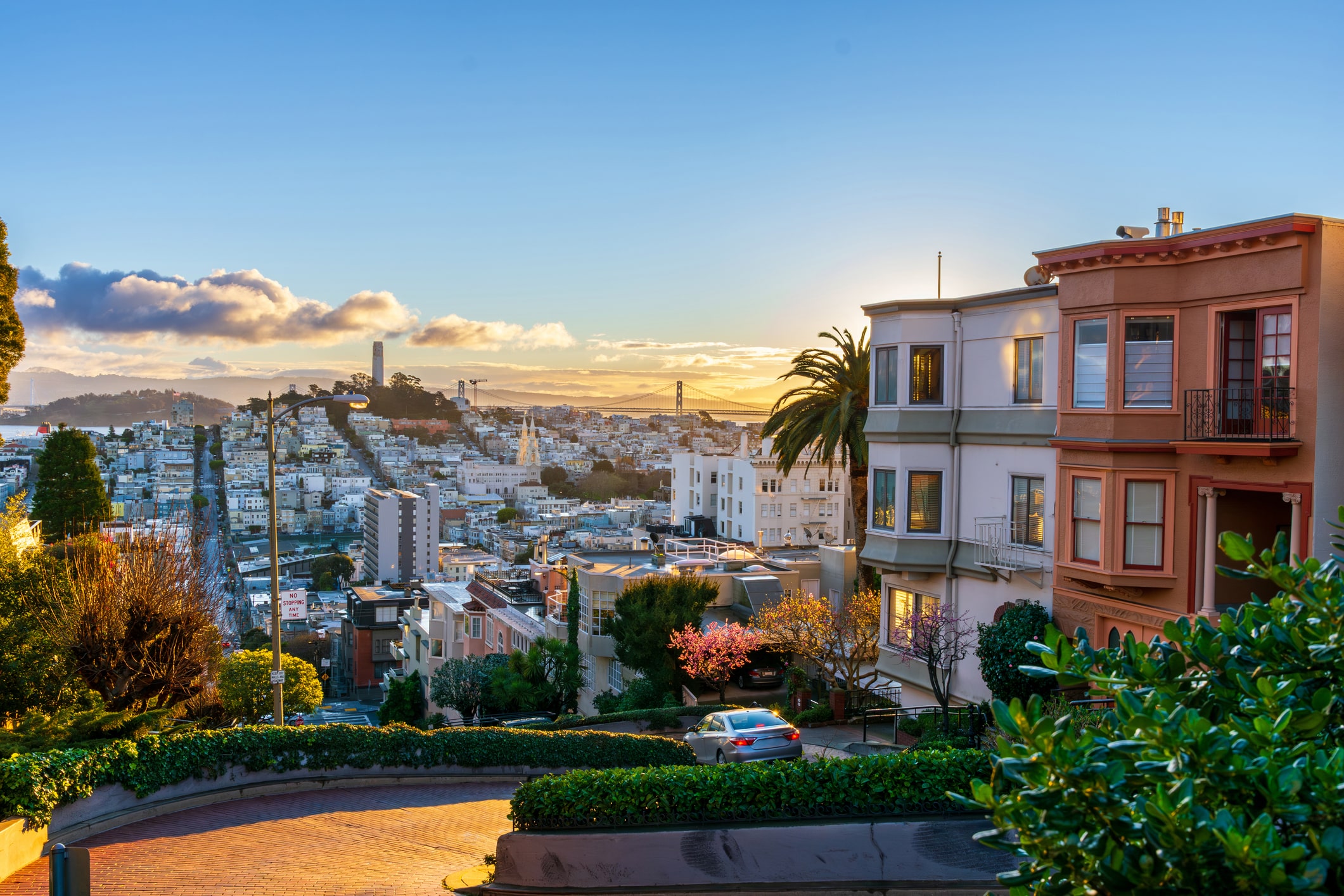 Lombard Street with views of San Francisco and the Golden Gate Bridge.