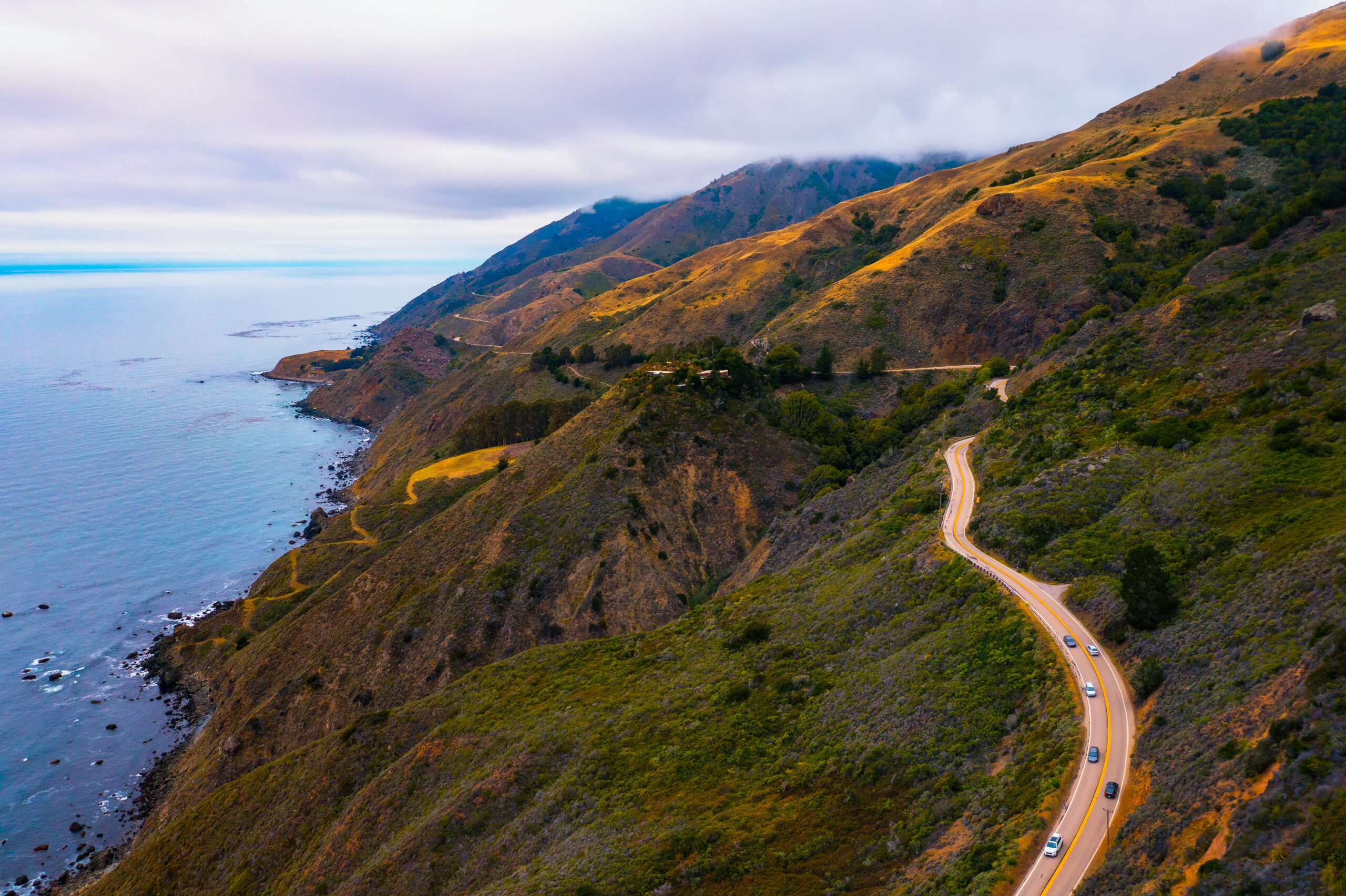 Aerial view of the Pacific Coast Highway going along the coastline in California, USA.<br />
